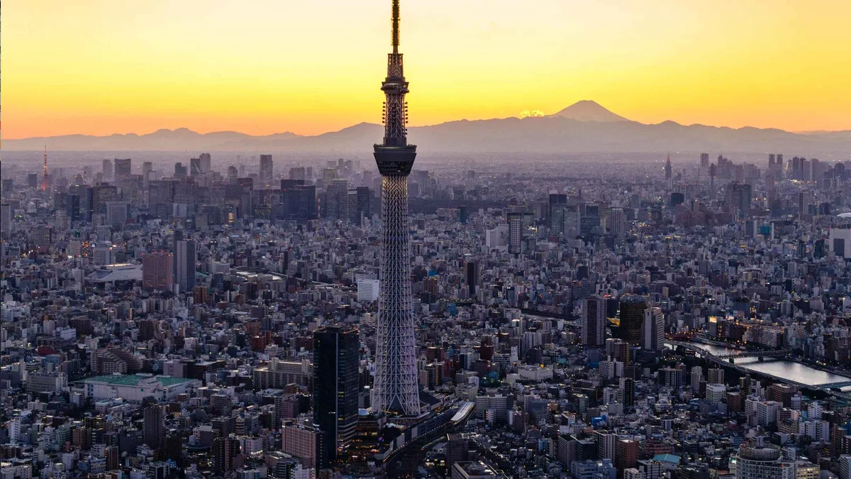 Visitor holding a subway pass with Tokyo Skytree observation deck views in the background, Tokyo Japan