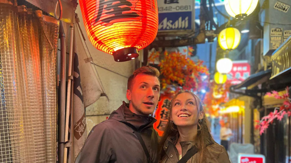 Small group sampling yakitori skewers at a Shinjuku izakaya on a Tokyo food tour, Shinjuku Tokyo