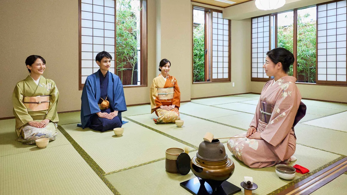 Visitor in a rented kimono whisking matcha during a tea ceremony in Asakusa, Tokyo Japan
